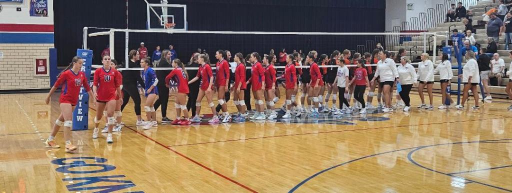 Volleyball teams Crestview Lady Knights and Coldwater Cavaliers shaking hands after the match in a gymnasium.