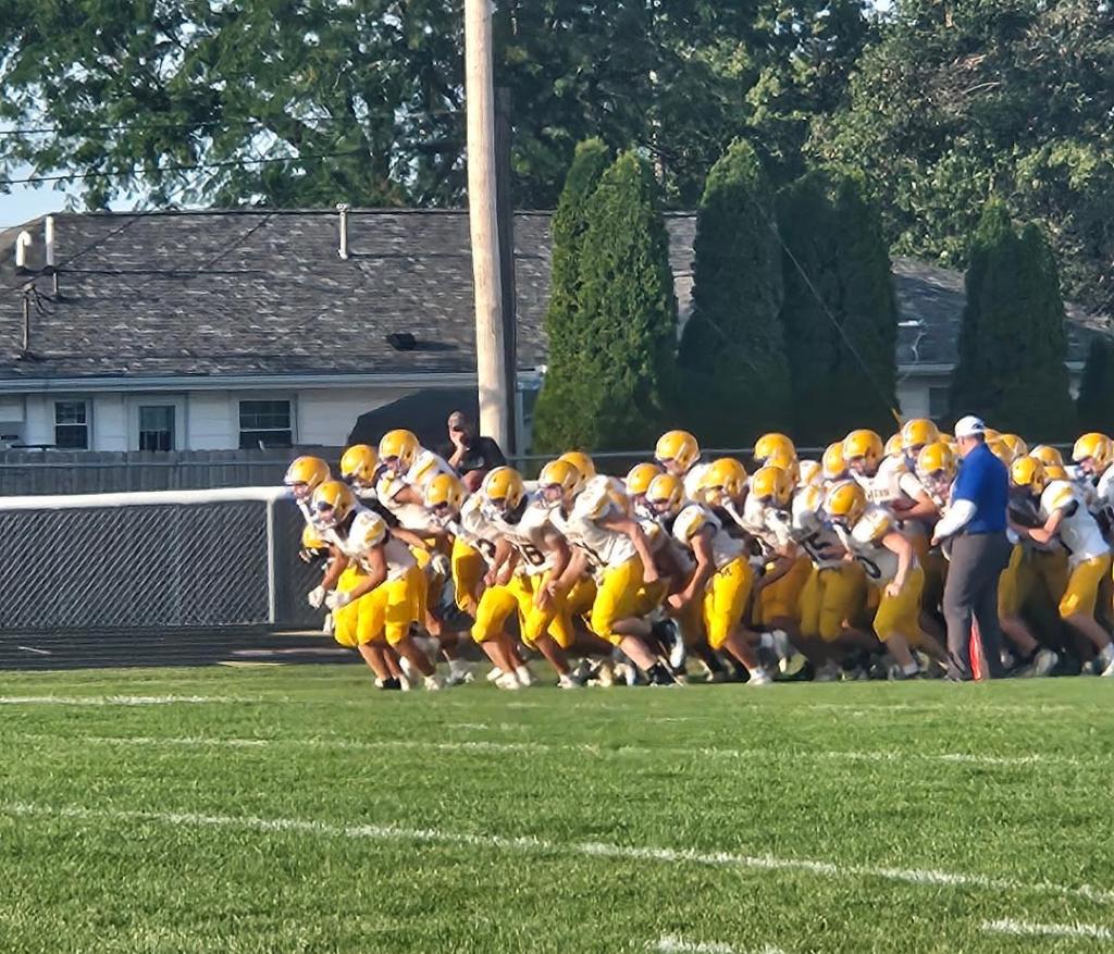 Crestview Knights football team running onto the field before the game.