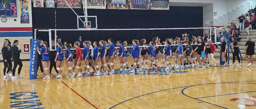 Crestview Lady Knights and New Bremen Cardinals shaking hands after a volleyball match at Crestview.
