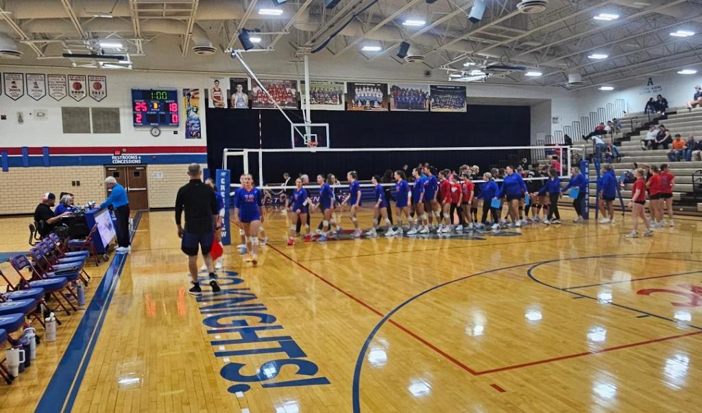 Crestview Lady Knights Volleyball Team and Spencerville Bearcats shaking hands after the match, with the scoreboard showing a final score of 25-18.
